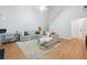 Open concept living room with laminate wood flooring, ceiling fan, and natural light at 4104 Glenaire Nw Way, Acworth, GA 30101