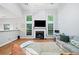 Bright living room with a fireplace, large windows, and a cozy seating arrangement, perfect for relaxation at 4104 Glenaire Nw Way, Acworth, GA 30101