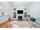 Bright living room features hardwood floors, large windows, a fireplace, and a tall ceiling at 4104 Glenaire Nw Way, Acworth, GA 30101