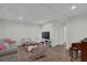 Basement living area with wood floors, television, and white walls at 7155 Bannister Park Ln, Cumming, GA 30028