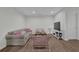 Finished basement featuring a cozy seating area and modern furnishings with great lighting at 7155 Bannister Park Ln, Cumming, GA 30028
