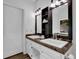 Bathroom vanity with double sinks, granite countertop, and a stylish barn door at 7155 Bannister Park Ln, Cumming, GA 30028