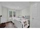 Bright basement bedroom with two twin beds, natural light, and wood-look floors at 7155 Bannister Park Ln, Cumming, GA 30028