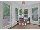 Bright breakfast nook features a small table and chairs next to a door that leads to the deck at 7155 Bannister Park Ln, Cumming, GA 30028