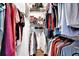 Organized walk-in closet with clothing racks and shoe shelves, maximizing storage space at 7155 Bannister Park Ln, Cumming, GA 30028