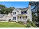 Charming two-story home boasts a well-kept lawn, a covered front porch, and mature trees at 7155 Bannister Park Ln, Cumming, GA 30028