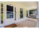 Cozy covered front porch featuring a porch swing for relaxing outdoor moments at 7155 Bannister Park Ln, Cumming, GA 30028