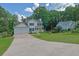 Inviting two-story home with blue shutters, attached garage, and a lush green lawn at 7155 Bannister Park Ln, Cumming, GA 30028