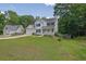 Charming two-story home featuring a well-manicured lawn, an attached garage, and inviting front porch at 7155 Bannister Park Ln, Cumming, GA 30028