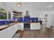 Bright, open kitchen with white cabinets, wood countertops, and decorative shelving at 7155 Bannister Park Ln, Cumming, GA 30028