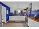Bright kitchen with blue backsplash, butcher block countertops, and stainless steel appliances at 7155 Bannister Park Ln, Cumming, GA 30028