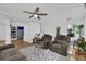Open-concept living area with hardwood floors, cozy furniture, and a view into other rooms at 7155 Bannister Park Ln, Cumming, GA 30028