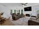 Bright living room features a cozy seating arrangement, fireplace, and hardwood floors at 7155 Bannister Park Ln, Cumming, GA 30028