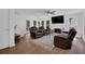 Inviting living room with a cozy seating arrangement, fireplace, and ample natural light at 7155 Bannister Park Ln, Cumming, GA 30028