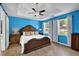 Spacious main bedroom with a large bed, ceiling fan, and bright natural light from the windows at 7155 Bannister Park Ln, Cumming, GA 30028