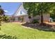 Brick house backyard with well maintained lawn and small decorative trees at 10110 Malcolm Ct, Covington, GA 30014