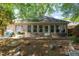 Brick house backyard with small patio and lots of foliage providing privacy at 10110 Malcolm Ct, Covington, GA 30014