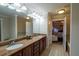 Bright bathroom with a long double sink vanity with stone countertop with bathtub and bedroom access at 10110 Malcolm Ct, Covington, GA 30014