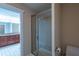 Bathroom with glass enclosed shower with the double sink vanity and water closet visible in the distance at 10110 Malcolm Ct, Covington, GA 30014