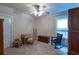 Cozy bedroom with classic furniture, plush carpet, and plenty of natural light at 10110 Malcolm Ct, Covington, GA 30014