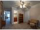 Cozy carpeted bedroom with ceiling fan, storage, and access to the bathroom at 10110 Malcolm Ct, Covington, GA 30014
