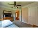 Inviting bedroom with a ceiling fan, neutral walls, and plush carpet at 10110 Malcolm Ct, Covington, GA 30014