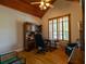 Comfortable bedroom featuring hardwood floors, a desk, and shuttered windows at 10110 Malcolm Ct, Covington, GA 30014