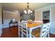Bright dining room features hardwood floors, chandelier and seating for eight at 10110 Malcolm Ct, Covington, GA 30014