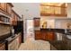 Kitchen with stainless appliances, granite counters and open floor plan to living area at 10110 Malcolm Ct, Covington, GA 30014