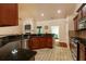 Stylish kitchen with granite countertops, stainless steel appliances and wood cabinetry at 10110 Malcolm Ct, Covington, GA 30014