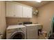 Functional laundry room with washer, dryer, sink, and storage shelves at 10110 Malcolm Ct, Covington, GA 30014