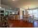Open-concept living area with hardwood floors, fireplace, and a breakfast bar at 10110 Malcolm Ct, Covington, GA 30014