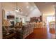 Spacious living room with fireplace, open to kitchen with bar seating, and dining area with lots of light at 10110 Malcolm Ct, Covington, GA 30014
