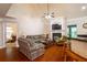 Comfortable living room with fireplace, hardwood floors, and access to other rooms at 10110 Malcolm Ct, Covington, GA 30014