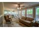 Bright sun room with windows on all sides, lots of seating, ceiling fans, and access to the outside at 10110 Malcolm Ct, Covington, GA 30014