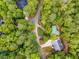 Aerial view of home surrounded by lush trees with a winding driveway at 10213 Tall Pine Ct, Villa Rica, GA 30180