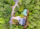 An aerial view of the house showcasing the roof, driveway, and surrounding lush trees at 10213 Tall Pine Ct, Villa Rica, GA 30180