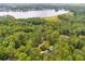 An aerial view capturing a lake view with lush treeline and several residences below at 10213 Tall Pine Ct, Villa Rica, GA 30180