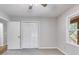 A well-lit bedroom offers a ceiling fan and a closet with gray walls at 10213 Tall Pine Ct, Villa Rica, GA 30180