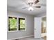 Bright bedroom with a ceiling fan, gray walls, carpet flooring, and view to the backyard at 10213 Tall Pine Ct, Villa Rica, GA 30180