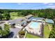 Aerial view of the community pool and tennis courts, showcasing recreational amenities amidst lush greenery at 10213 Tall Pine Ct, Villa Rica, GA 30180