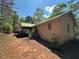 View of the home's exterior shows off beautiful trees and natural light at 10213 Tall Pine Ct, Villa Rica, GA 30180