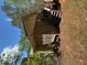 View of a light-yellow home with a green metal roof and an enclosed porch at 10213 Tall Pine Ct, Villa Rica, GA 30180