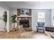 Cozy living room with a stone fireplace, hardwood floors, and neutral decor at 10213 Tall Pine Ct, Villa Rica, GA 30180