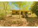 Charming single-story home featuring a welcoming front porch and lush, natural surroundings at 10213 Tall Pine Ct, Villa Rica, GA 30180