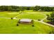 Aerial view of a picturesque golf course featuring a shelter and smooth green fairways at 10213 Tall Pine Ct, Villa Rica, GA 30180