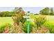 Scenic golf course signage amidst lush greenery and colorful flowers, enhancing the golfing experience at 10213 Tall Pine Ct, Villa Rica, GA 30180