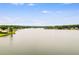 Tranquil lake view showing the vast expanse of water, with tree-lined shores and several homes in the distance at 10213 Tall Pine Ct, Villa Rica, GA 30180
