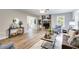 Spacious living room featuring a stone fireplace, hardwood floors, and an open layout at 10213 Tall Pine Ct, Villa Rica, GA 30180