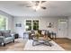 Bright living room with hardwood floors, comfortable seating, and natural light at 10213 Tall Pine Ct, Villa Rica, GA 30180